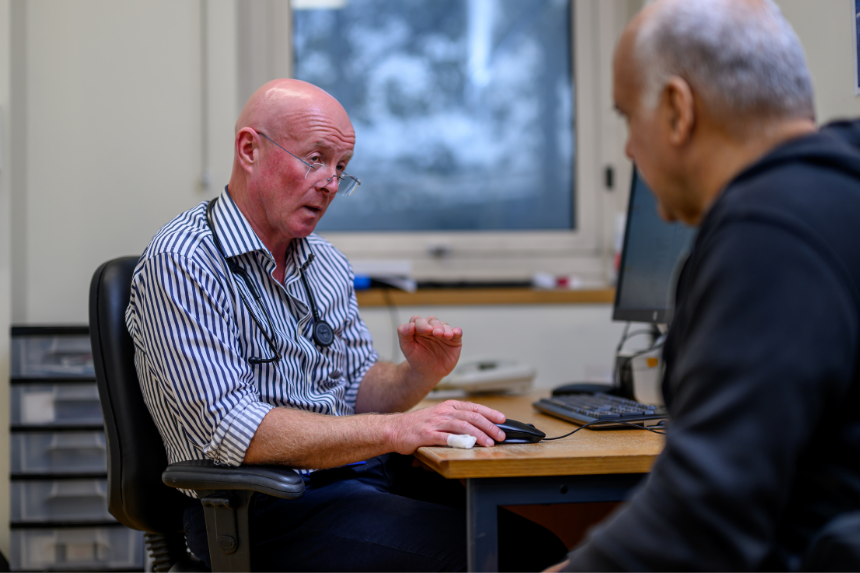 Clinician talking to male patient