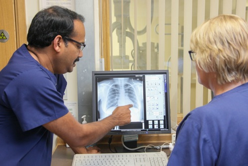 X Ray Ct Scan Man And Woman Looking At Screen